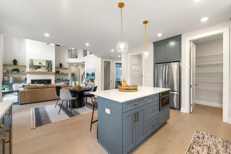 builder for custom homes farmhouse kitchen with oversized island, living space with built in shelving