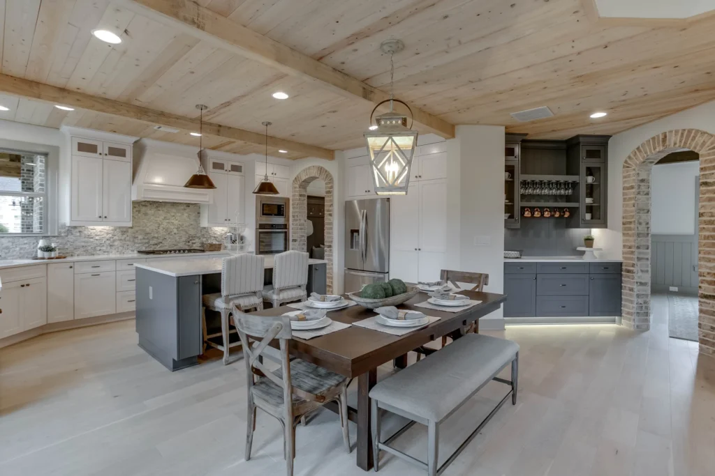 CAD Home Crafters & Designs - Builder for custom homes Craftsman style home in Rockingham County, NC, dream farmhouse kitchen with rustic cottage lighting and custom millwork, butler's pantry with interior brick archways